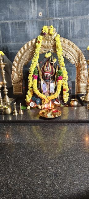 The sanctum with brass arch and lamps