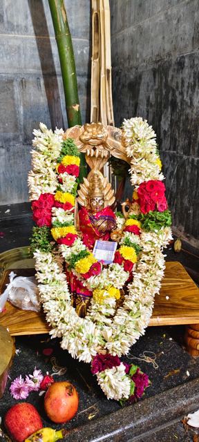 Utsava murti with jasmine and rose garlands